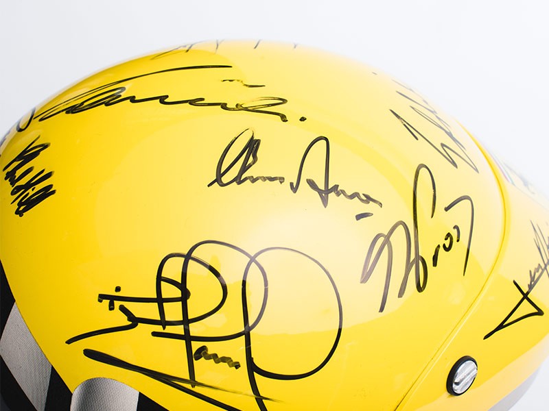 Ferrari helmet signed by Ferrari F1 drivers.